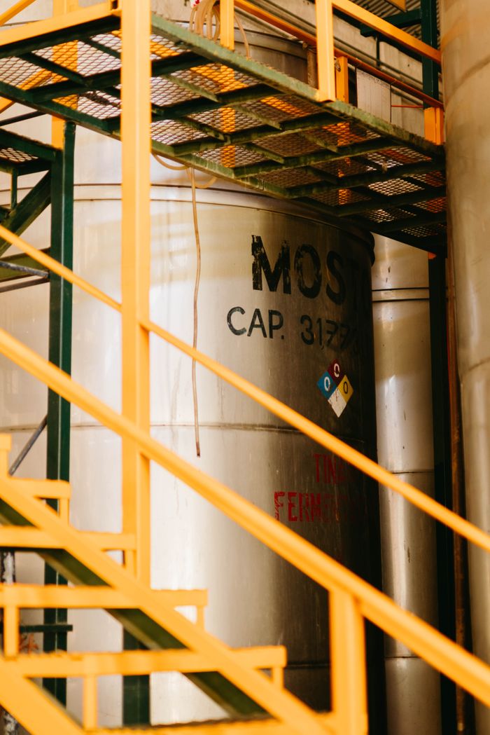 services-img A stainless steel tank with industrial railings, showcasing structural design.