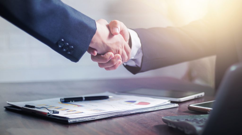 pexels photo 4175028 4175028 Professional handshake agreement over business charts in an office setting.